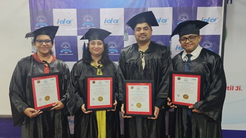 Four graduates of the Fellowship in Geriatric Dentistry holding their certificates
